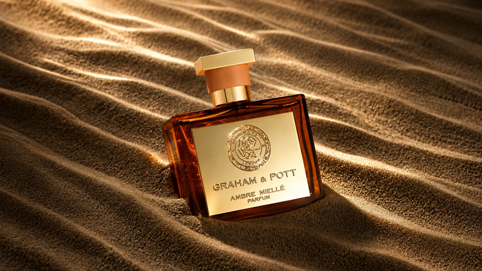 Ambre Mielle by Graham & Pott: Luxury Fragrance Film, Hero bottle on rippled fabric